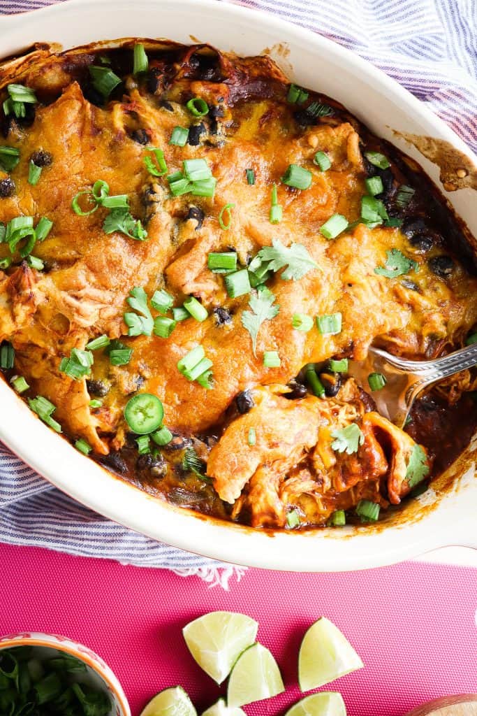 This truly is the Easiest Chicken Enchilada Bake you will ever find, and it's just as delicious.  Filled with shredded chicken, black beans, red enchilada sauce, and tortillas and then topped with melty cheddar cheese. 