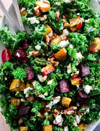 Roasted Beet Kale Salad with Goat Cheese and Walnuts on a white serving platter