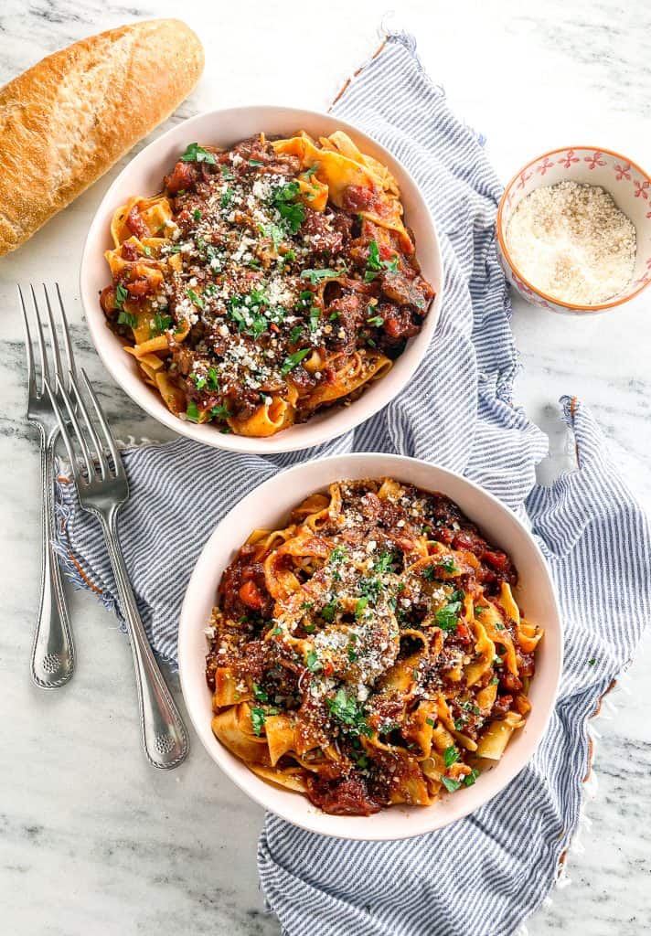 date night short rib ragu recipe in bowls with bread and parmesan 