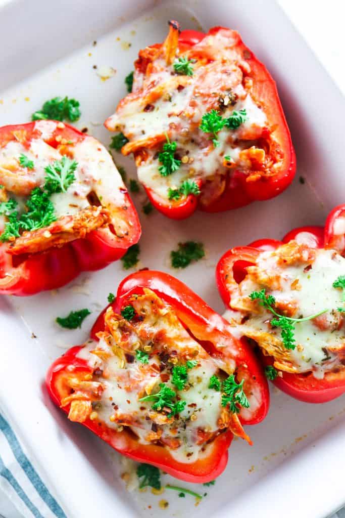 marinara chicken in red bell peppers topped with cheese and parsley