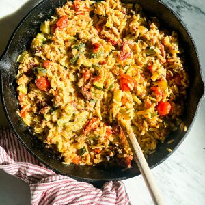 One pot sausage orzo with sun-dried tomatoes and zucchini Made in a cast iron skillet