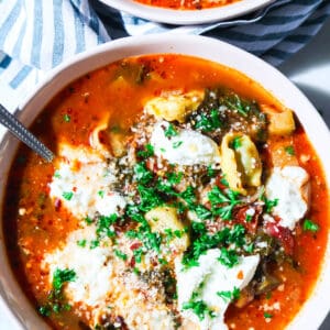 lasagna soup with tortellini topped with ricotta and parmesan