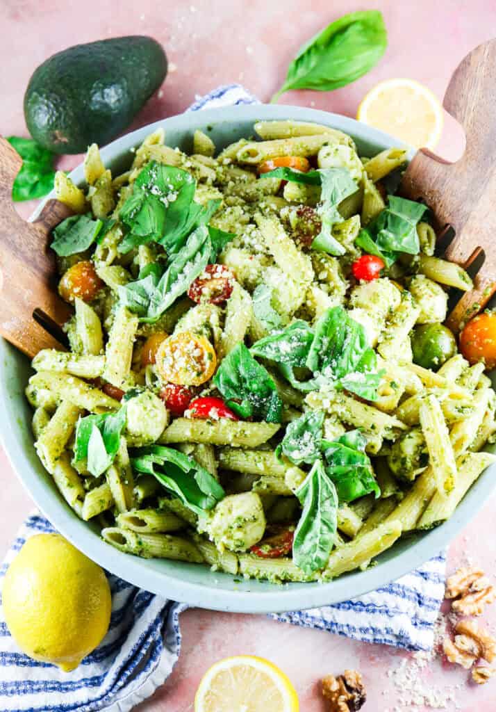 pesto caprese penne pasta with fresh basil, mini heirloom tomatoes, and grated parmesan with fresh lemon