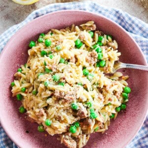 one pot sausage orzo with peas and parmesan with lemon zest and juice