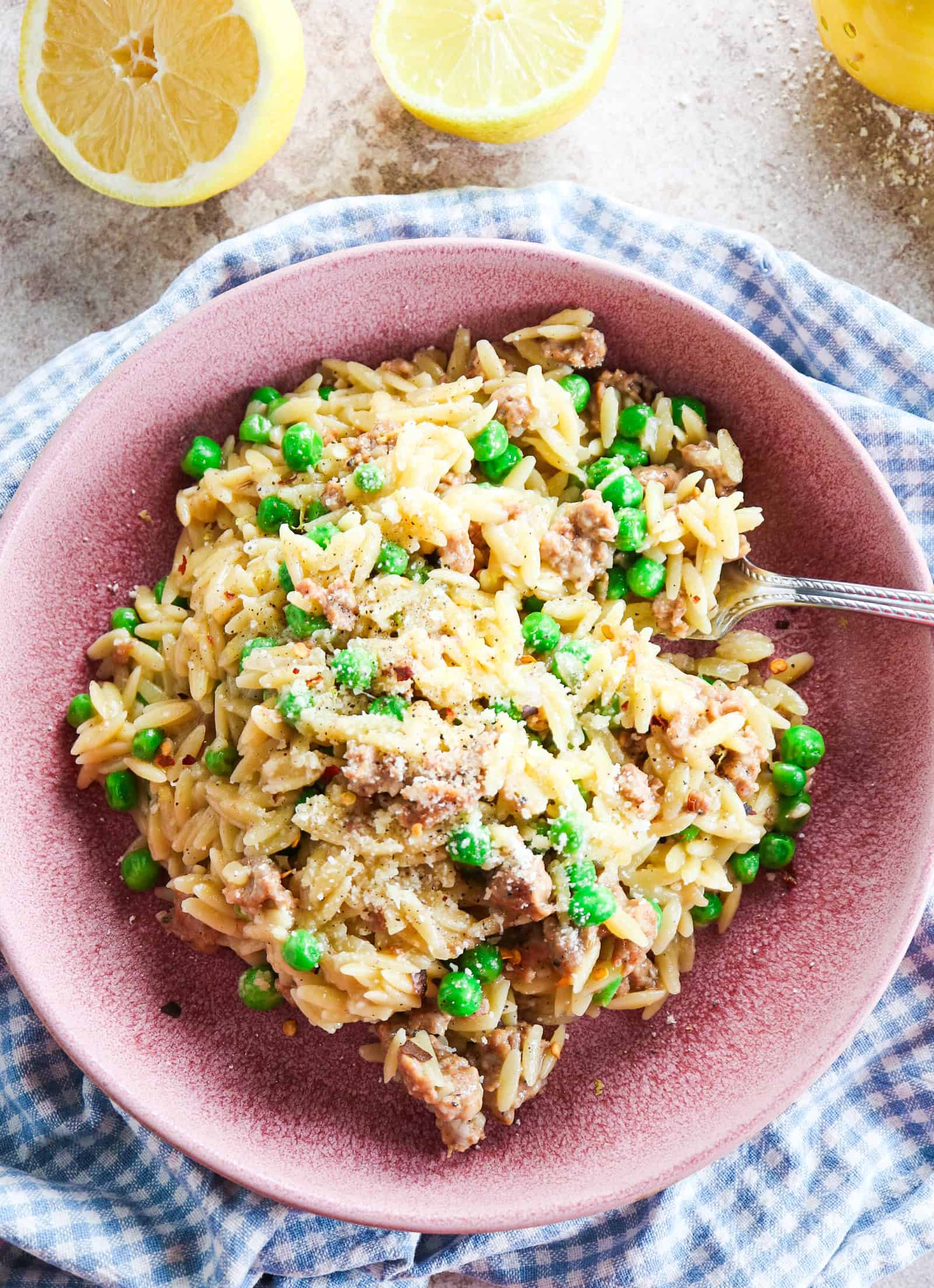 one pot sausage orzo with peas and parmesan with lemon zest and juice