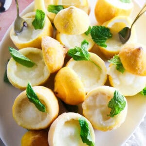Lemon sorbetto cups served in hollowed out lemons garnished with mint leaves