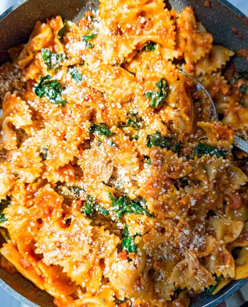easiest fall pasta using farfalle, pancetta, kale, trader joes fall pasta sauce, and shallots